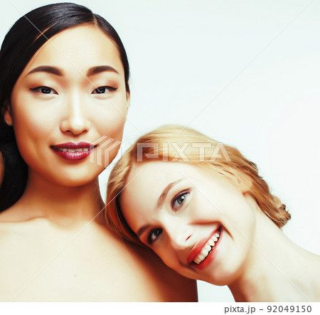different nation woman: caucasian and asian together isolated on white background happy smiling, diverse type on skin, lifestyle people concept close up different nation woman: caucasian and asian together isolated on white background happy smiling, diverse type on skin, lifestyle people concept close up 92049150