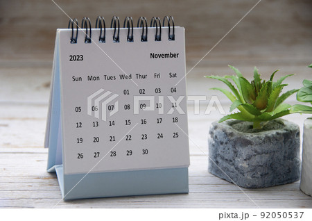 November 2023 white desk calendar on wooden table. Copy space 92050537