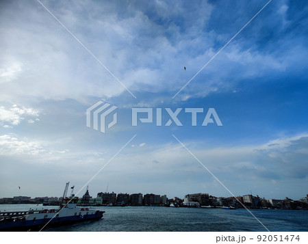 Seagulls flying and Fishing by the sea side with the background of the ocean and the blue sky Seagulls flying and Fishing by the sea side with the background of the ocean and the blue sky 92051474