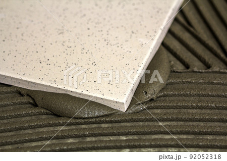 Ceramic tiles and tools for tiler. Floor tiles installation. Home improvement, renovation - ceramic tile floor adhesive, Ceramic tiles and tools for tiler. Floor tiles installation. Home improvement, renovation - ceramic tile floor adhesive, 92052318