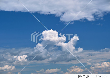 Bright landscape of white puffy cumulus clouds on blue clear sky. Bright landscape of white puffy cumulus clouds on blue clear sky. 92052332