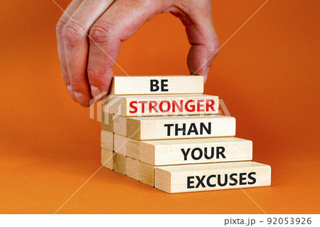 Be stronger symbol. Concept words Be stronger than your excuses on wooden blocks on a beautiful orange table orange background. Businessman hand. Business motivational and be stronger concept. 92053926