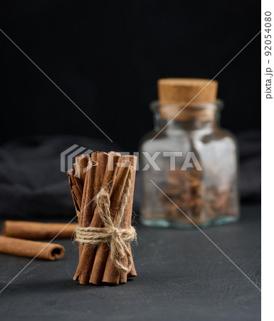 Bunch of dry cinnamon on black table, spice 92054080