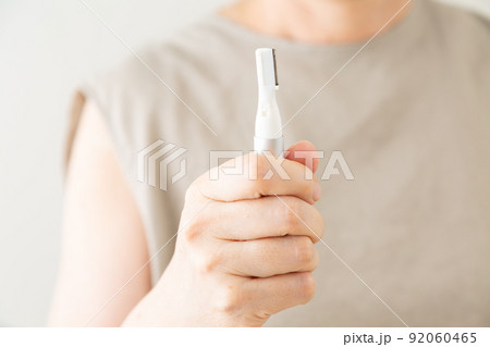 腕の毛を剃るミドル女性 92060465