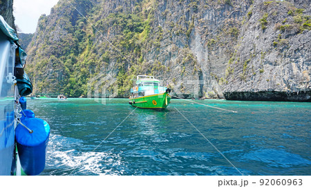Blue water, green hills and steep rocks. Blue water, green hills and steep rocks. 92060963