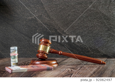 Judges hammer, Dollard bank notes, Euro bank Notes, on a wooden background. Concept for a financial judgments, high Quality Photo 92062497