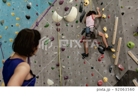 A girl climbing rock mountain 92063560