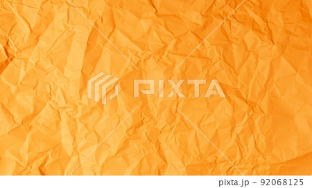 The orange paper background is wrinkled, creating a rough texture with light and shadow. 92068125