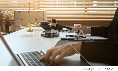 Cropped shot of senior female judge working on laptop computer, online legal advice 92068521
