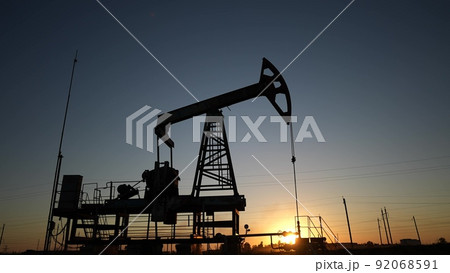 oil production. silhouette oil and gas production rig at sunset glare. oilfield business a extraction concept. oil extraction pump. Oil lifestyle pump rig 92068591