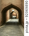 Secret streets, labyrinths paved with stone tiles, among windowless houses covered with adobe arches  in the city of Yazd. 92069890