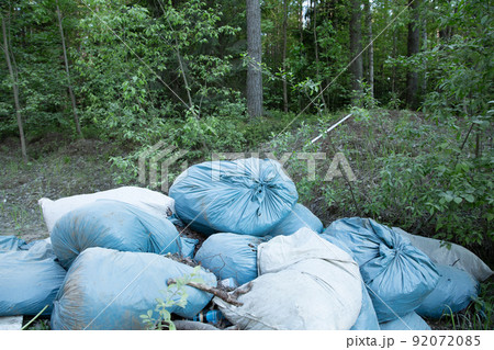 Garbage and pollution. Environmental protection or volunteering for charity, Waste disposal through recycling. Waste is densely deposited in the forest background. Ecological problem concept. Garbage and pollution. Environmental protection or volunteering for charity, Waste disposal through recycling. Waste is densely deposited in the forest background. Ecological problem concept. 92072085