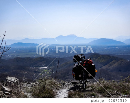 Loaded touring bicycle with mountains in the background 92072519