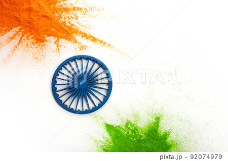 Orange and green color powder splash with Ashoka wheel. Concept for India independence day, 15th of august. 92074979