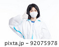 girl in a protective suit on a white background 92075978