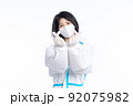 girl in a protective suit on a white background 92075982