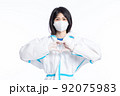 girl in a protective suit on a white background 92075983