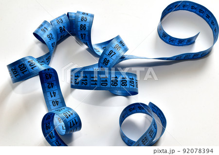 Blue meter of a seamstress lies on a white background. 92078394