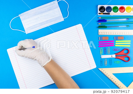 The child writes on a notebook The child writes on a notebook 92079417