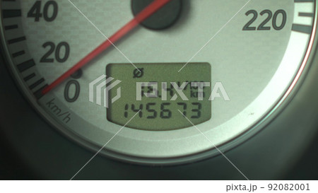 Switching the display of fuel and mileage indicators on the panel in the car. Automobile panel close up. 92082001