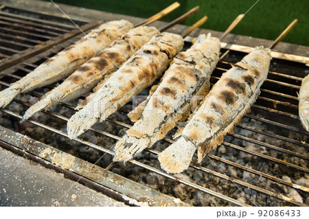 Top view of grilled snake-head fish on the stainless colander, focus selective 92086433