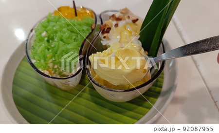 Mango ice cream on a spoon Mango ice cream on a spoon 92087955