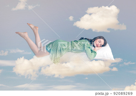 Relaxed girl in ruffle dress levitating in mid-air, sleeping on stomach lying comfortable cozy on pillow, keeping eyes closed, watching peaceful dream. collage composition on day cloudy blue sky 92089269