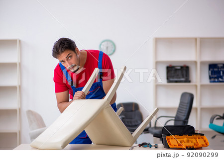 Young male carpenter working at workshop Young male carpenter working at workshop 92090299