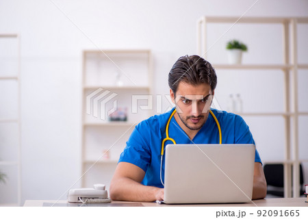 Young male doctor in telemedicine concept Young male doctor in telemedicine concept 92091665