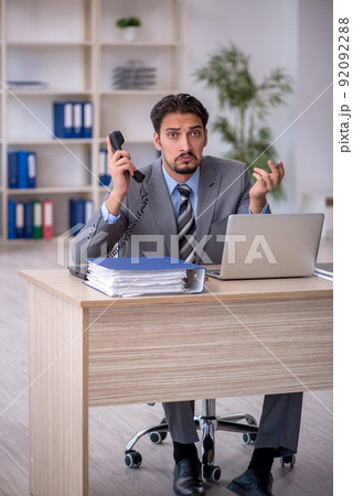 Young male employee working in the office Young male employee working in the office 92092288