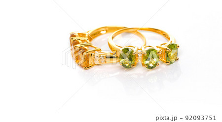 Citrine and Peridot with Diamond Jewel or gems ring on white background with reflection. Collection of natural gemstones accessories. Studio shot Citrine and Peridot with Diamond Jewel or gems ring on white background with reflection. Collection of natural gemstones accessories. Studio shot 92093751
