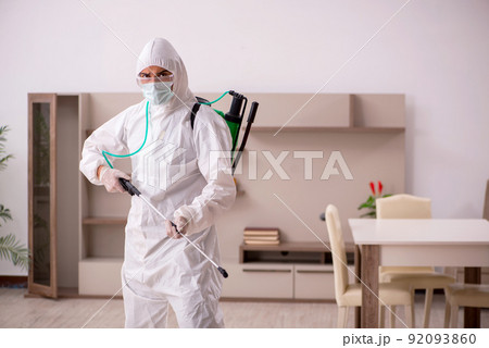 Young male contractor doing pest control at home Young male contractor doing pest control at home 92093860