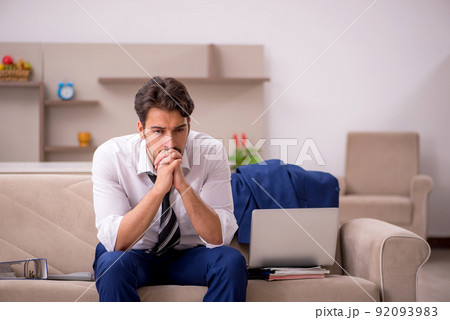 Young male employee working from home during pandemic Young male employee working from home during pandemic 92093983