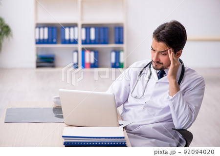 Young male doctor in telemedicine concept 92094020