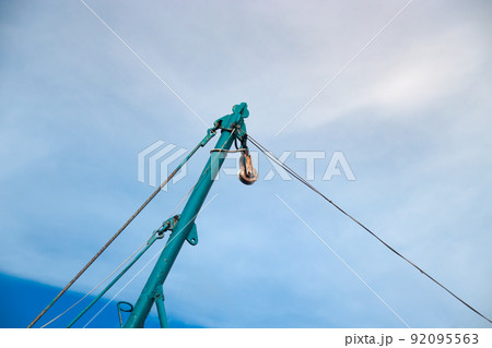 Mast of a boat against the blue clear sky on a summer day Mast of a boat against the blue clear sky on a summer day 92095563