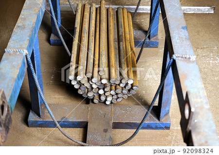 Blanks of metal rods at the factory for further processing. Warehousing and storage of prepared elements for metalworking. Blanks of metal rods at the factory for further processing. Warehousing and storage of prepared elements for metalworking. 92098324