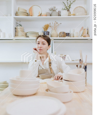woman ceramist in the workshop makes mugs out of clay. small business or hobby is the creation of ceramic products 92099616