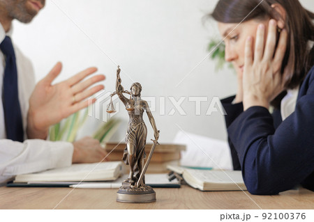 two lawyers, a man and a woman, check the contract, negotiate and conclude a deal, justice two lawyers, a man and a woman, check the contract, negotiate and conclude a deal, justice 92100376
