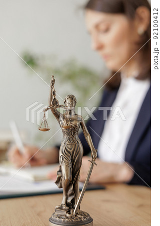 lawyer woman in a light jacket works in an office, a statuette of themis, the goddess of justice lawyer woman in a light jacket works in an office, a statuette of themis, the goddess of justice 92100412