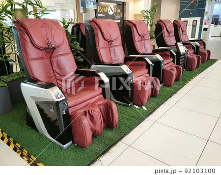 MELAKA, MALAYSIA -JUNE 8, 2022: Electric massage chairs are placed in public areas for use. Customers need to enter a certain amount of money to get this service. MELAKA, MALAYSIA -JUNE 8, 2022: Electric massage chairs are placed in public areas for use. Customers need to enter a certain amount of money to get this service. 92103100