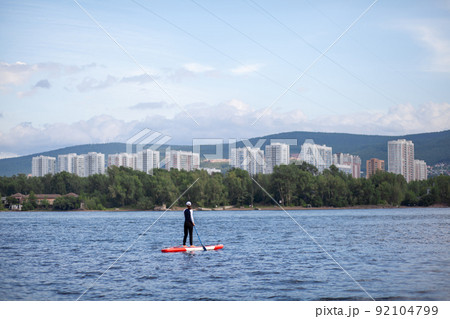SUP board Stand up paddle board woman paddle boarding on lake SUP board Stand up paddle board woman paddle boarding on lake 92104799