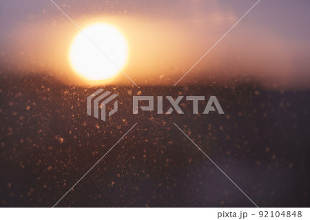 Closeup photo of dirty window with beautiful sunset on background 92104848