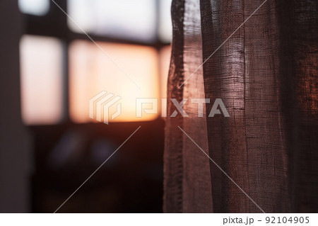 Window curtains in sunset light dark interior Window curtains in sunset light dark interior 92104905
