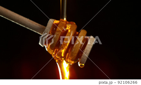 Honey dripping from wooden dripper. Honey dripping from wooden dripper. 92106266