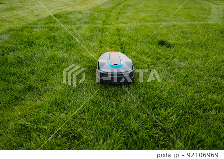 Automatic Lawn mower at garden. Copyspace. Banner photo 92106969