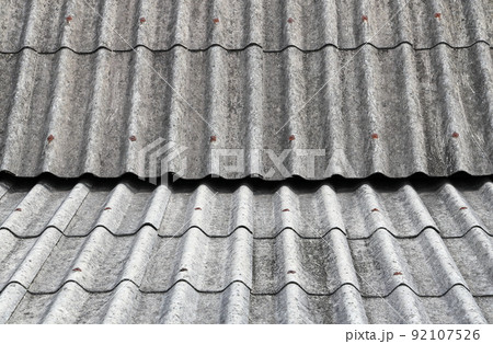 Old Asbestos cement roofing sheets, Asbestos roof, Corrugated Asbestos Cement Roof Sheet, corrugated panels, Gray slate texture,  Gray wavy slate roof pattern background. 92107526