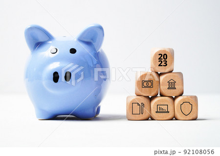 The concept of the new year 2023. Accumulating money and investing with piggy bank. The concept of the new year 2023. Accumulating money and investing with piggy bank. 92108056