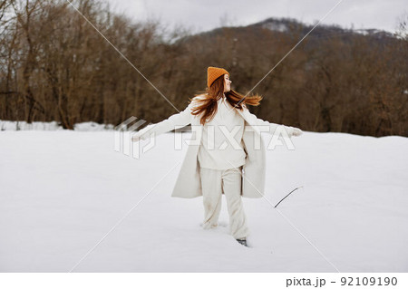 portrait of a woman in winter clothes in hats outdoors There is a lot of snow around portrait of a woman in winter clothes in hats outdoors There is a lot of snow around 92109190