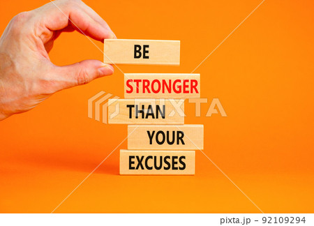 Be stronger symbol. Concept words Be stronger than your excuses on wooden blocks on a beautiful orange table orange background. Businessman hand. Business motivational and be stronger concept. Be stronger symbol. Concept words Be stronger than your excuses on wooden blocks on a beautiful orange table orange background. Businessman hand. Business motivational and be stronger concept. 92109294