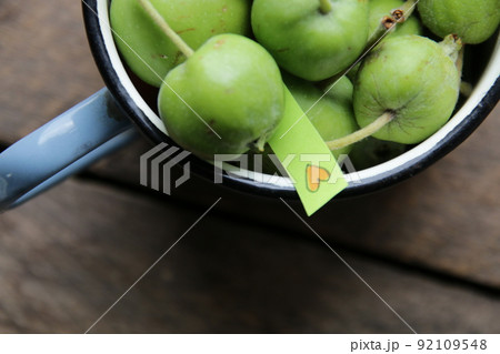 Natural food idea. Green apples and a tag with a heart. Natural food idea. Green apples and a tag with a heart. 92109548